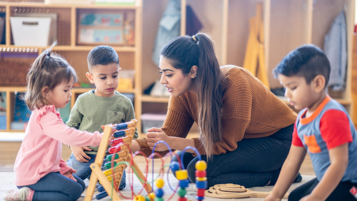 femaled kindergarten teacher with students