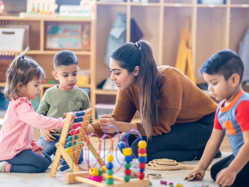 femaled kindergarten teacher with students